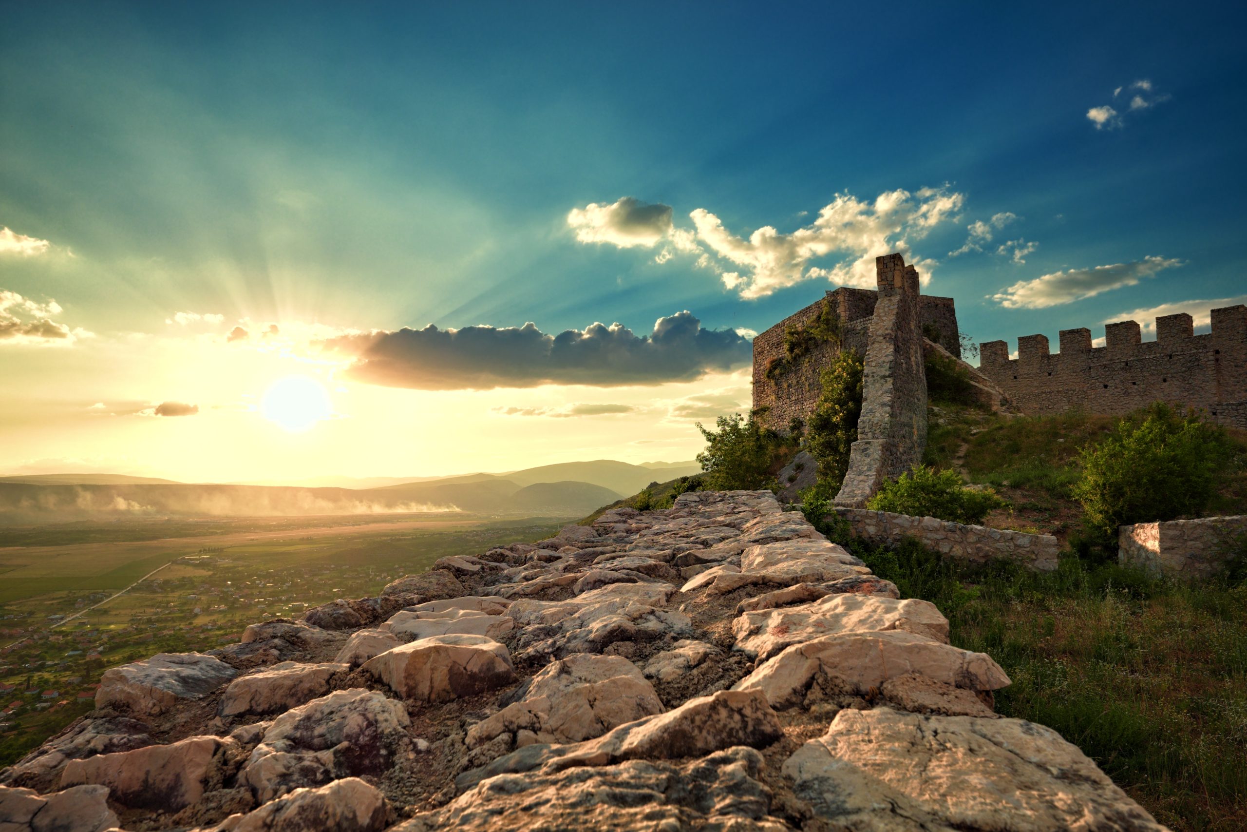 Stone walls of Blagaj Fortress above the valley at sunset